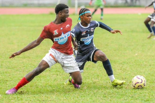 Eltham High School’s Antonio Fearon (left) finds himself going the wrong way against the dribble of Jamaica College’s Devonte Allen during their ISSA/WATA Manning Cup round-of-16 clash at the Jamaica College Ashenheim Stadium yesterday.