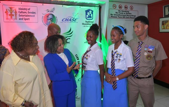 Minister of Culture, Gender, Entertainment and Sport Olivia Grange (left) and Minister of Education, Skills, Youth and Information Senator Dr Dana Morris Dixon interact with Ardenne High School students (from third left) Arhiyanna Kentish, Rihanna Henry an
