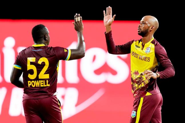 
West Indies’ Roston Chase (right) celebrating with Rovman Powell.
