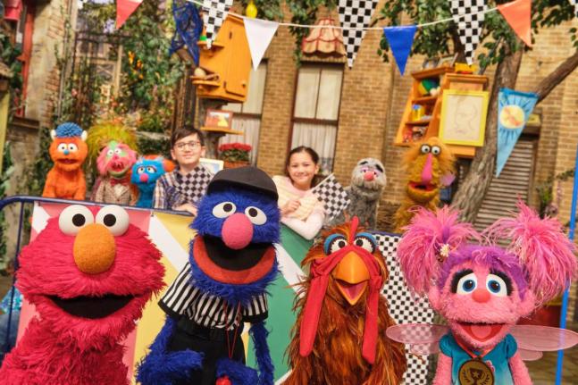 This image released by Sesame Workshop shows muppet characters Elmo (left), Grover (second left), and Abby (right), from the ‘Sesame Street’ episode ‘Elmo Runs the Race’.