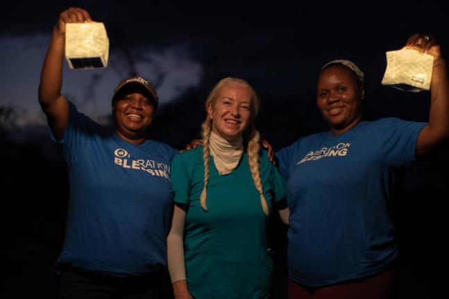 Dr Alison Thompson (centre) flanked by two Operation Blessing volunteers. 