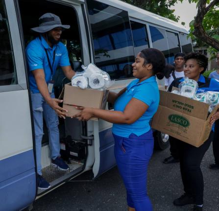 Flow team members (from left) Adrian Stewart, Patrice Todd, and Katoya Mohalland pack essential supplies at Flow’s corporate offices in Kingston as they get ready to assist residents in St James who were impacted by Hurricane Melissa.