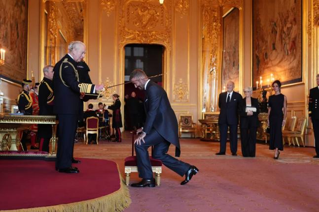 Sir David Beckham (right) is made a Knight Bachelor by Britain’s King Charles III during an Investiture ceremony at Windsor Castle, Berkshire, England,