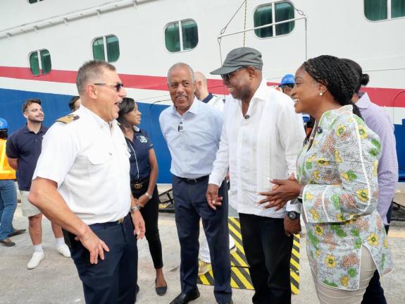 Tourism Minister, Edmund Bartlett (second right), converses with Captain of the Carnival Horizon, Rocco Lubrano (left), on arrival at the Reynolds Pier, Ocho Rios, St Ann on Tuesday, November 4 where supplies were handed over to assist with Jamaica’s Hur