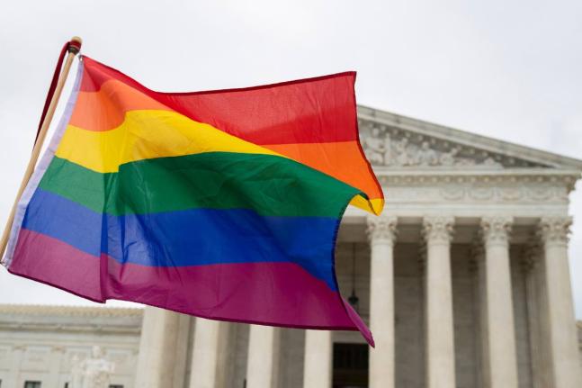 LGBT supporters wave a flag in front of the US Supreme Court, October 8, 2019, in Washington. (AP Photo/Manuel Balce Ceneta, File)