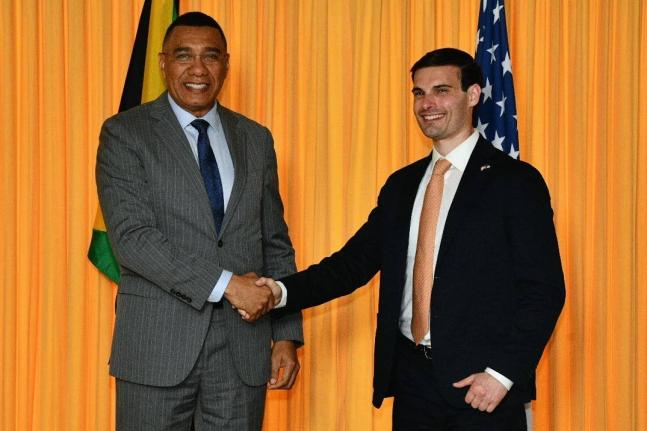 Prime Minister, Dr Andrew Holness (left), shakes hands with United Sates Under Secretary for Foreign Assistance, Humanitarian Affairs and Religious Freedom, Jeremy Lewin, following a meeting at the Office of the Prime Minister on Monday, November 10.