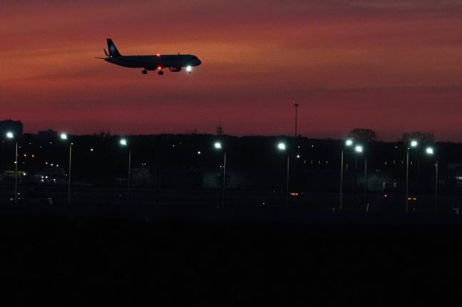 An airplane prepares to land at O'Hare International Airport, in Chicago, Wednesday, November 12, 2025. (AP Photo/Nam Y. Huh)