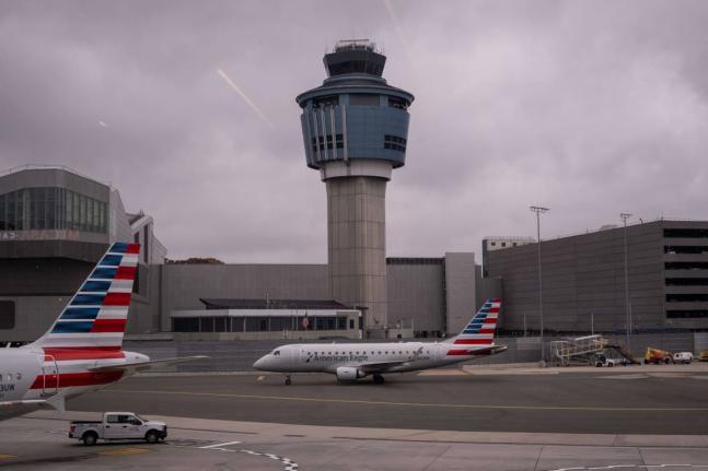 An American Eagle plane moves past the FAA Air Traffic Control tower at LaGuardia Airport (LGA) in the Queens borough of New York, Sunday, November 9, 2025. (AP Photo/Adam Gray)