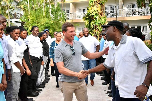 Executive Chairman of Sandals Resorts, Adam Stewart (centre), interacts with team members during his visit to the resorts following the passage of Hurricane Melissa.