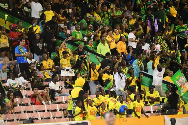 Reggae Boyz fans celebrate after Jamaica scored a goal against Bermuda at the National Stadium on October 14.