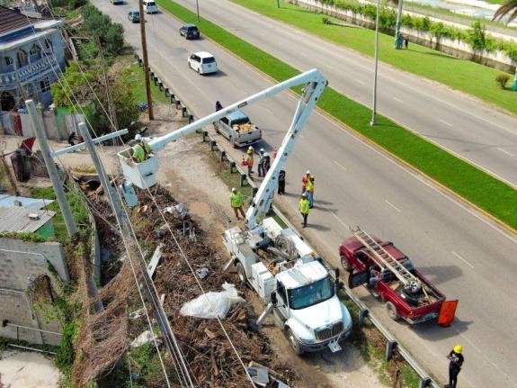 Lineworkers from Jamaica and overseas in Montego Bay on Sunday.