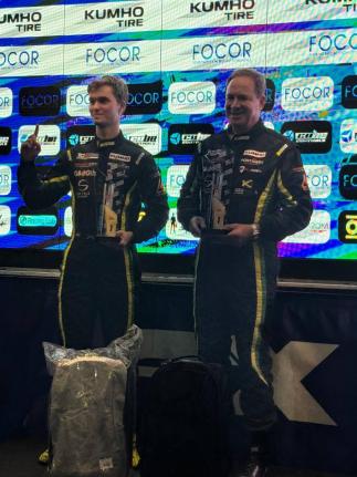 Senna Summerbell (left) and Christopher Issa accepting the winning trophy as the first Jamaicans drivers to win a European Drivers Championship.