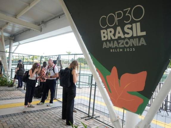 Attendees stand outside the venue for the COP30 UN Climate Summit after they were asked to leave, Thursday, Nov. 20, 2025, in Belem, Brazil. (AP Photo/Fernando Llano)
