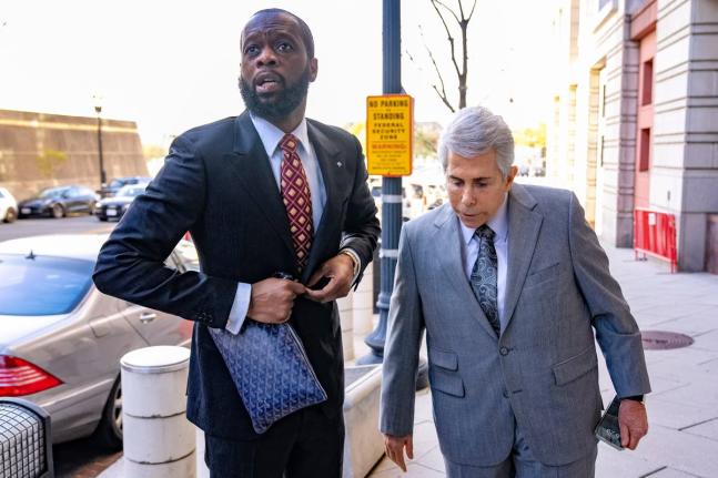 Prakazrel Pras Michel, a member of the 1990s hip-hop group the Fugees, accompanied by defence lawyer David Kenner (right), arrives at federal court April 3, 2023, in Washington.