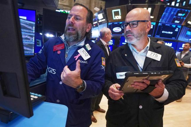 Specialist Michael Pistillo, left, and trader Fred Demarco work on the floor of the New York Stock Exchange. (AP)