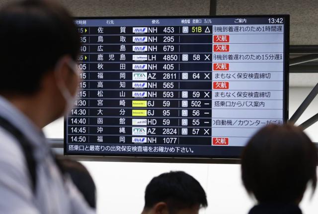 The departures display board shows All Nippon Airways' multipule flights cancellation at Haneda airport in Tokyo Saturday, November 29, 2025. (Takahiko Kanbara/Kyodo News via AP)