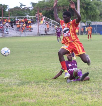 Ashley Anguin/Photographer 
Cornwall College’s Carlondo Morris (right) evades the challenge of William Knibb Memorial’s Gawen Marley during their round-of-16 ISSA daCosta Cup game at the Drax Hall Sports Complex in St Ann yesterday.