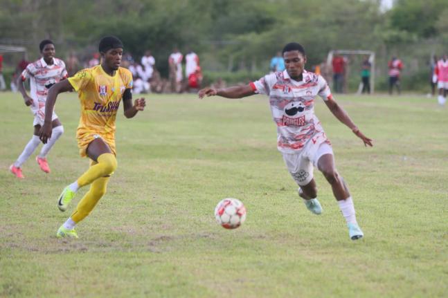 Orel Miller (right) of Glenmuir High powers past Garvey Maceo High’s  Tyreek McKenley during a first-round bottom-of-the-table daCosta Cup clash at Garvey Maceo on Tuesday, September 30. Glenmuir won 4-0. 