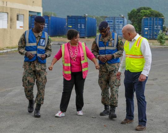 Seaboard Jamaica’s CEO, Corah Ann Robertson-Sylvester (second left), briefs (from left) Colonel Anthony Gregory, Major Dwayne Trowers, and Pan Jamaica Group Vice-Chairman and CEO Jeffrey Hall, on the coordinated efforts behind the donation of eight 40-fo