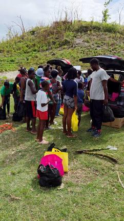 Residents of Giddy Hall, St Elizabeth receive care packages from Give Back Jamaica following Hurricane Melissa.