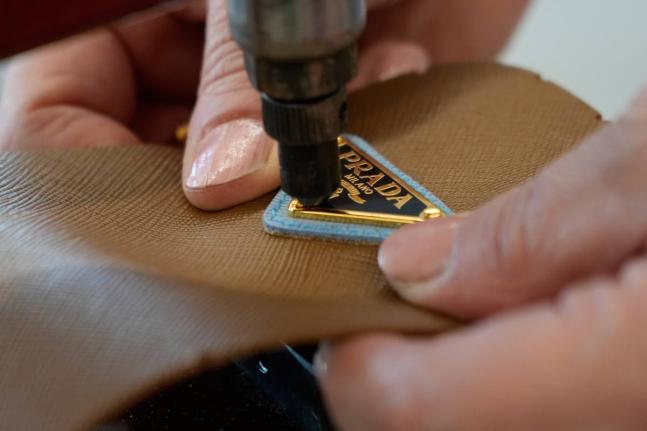 A leather good operator works at the Prada factory in Scandicci, Italy.