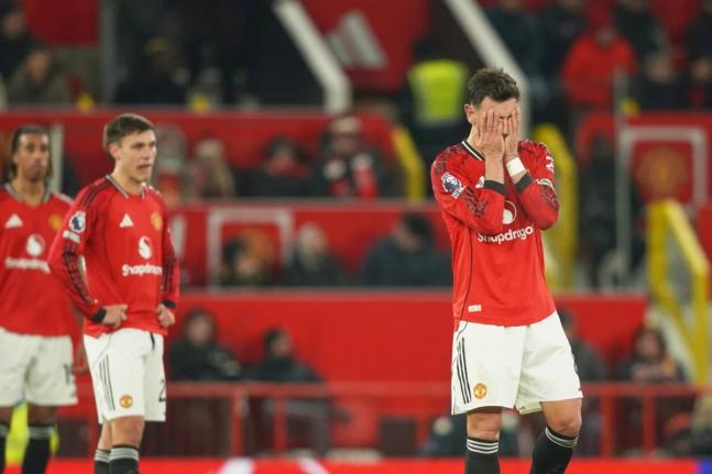 Manchester United’s Bruno Fernandes (right) reacts after West Ham’s Soungoutou Magassa scored his side’s first goal during the English Premier League  match between Manchester United and West Ham United in Manchester, England, yesterday.