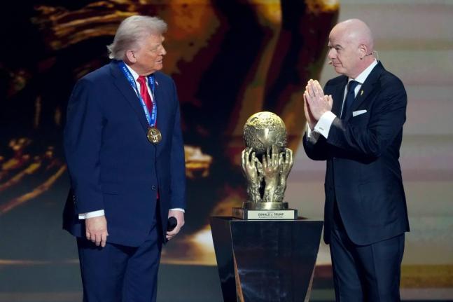 FIFA President Gianni Infantino (right) awards President Donald Trump with the FIFA Peace Prize during the draw for the 2026 football World Cup at the Kennedy Center in Washington yesterday.