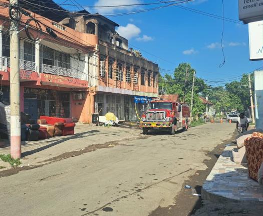 A fire truck at a building located at the corner of Williams Street and Young Street in Spanish Town, St Catherine that was damaged by a blaze on December 6, 2025.