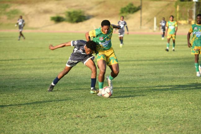 
Jamaica College’s (JC) Jamone Lyle and Excelsior High’s Shamarie Chambers get into an almighty tussle for possession during their ISSA/WATA Manning Cup quarterfinal football match at Stadium East yesterday. JC won the encounter 2-1.