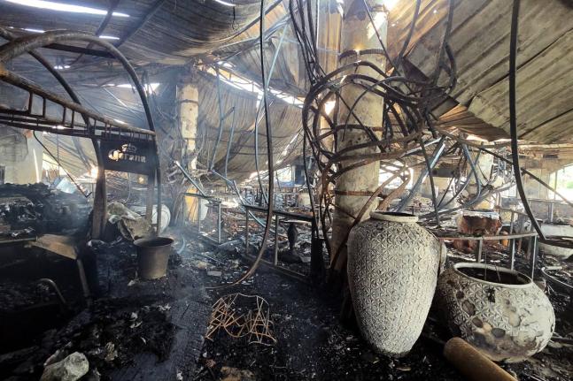 The charred interior of a nightclub, which caught fire early Sunday, is seen in Arpora, in Goa, India.
