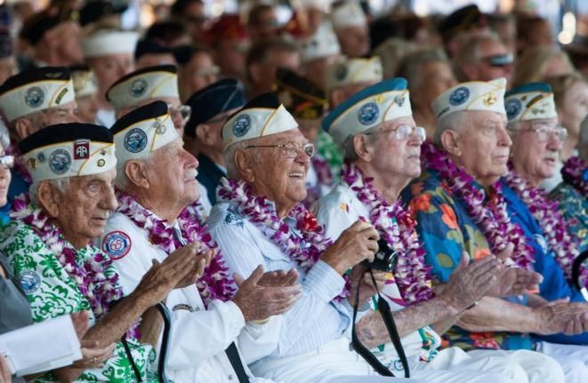Pearl Harbor survivors watch a vintage WWII airplane fly over Pearl Harbor at the ceremony commemorating the 72nd anniversary of the attack on Pearl Harbor, in 2013, in Honolulu.