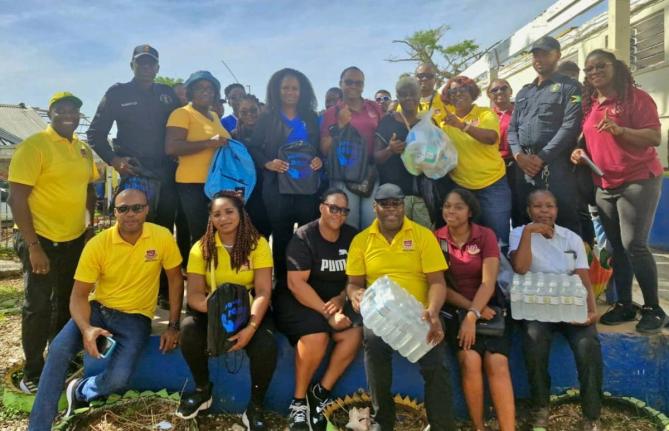 Members of the Friends of Region 6 are joined by Jamaica Constabulary Force personnel and educators during a visit to the Brampton Primary and Infant School in St Elizabeth on November 28. The group distributed hurricane relief supplies valued at over $500