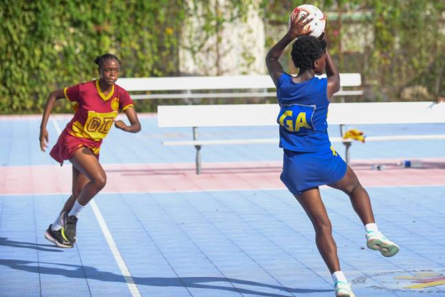 Wolmer’s Girls’ Schools’ Akayla Samuels (left) runs toward Mickayda Lyons of Jonathan Grant during the ISSA Urban Netball semi-finals at the Leila Robinson Courts, Kingston on Thursday.