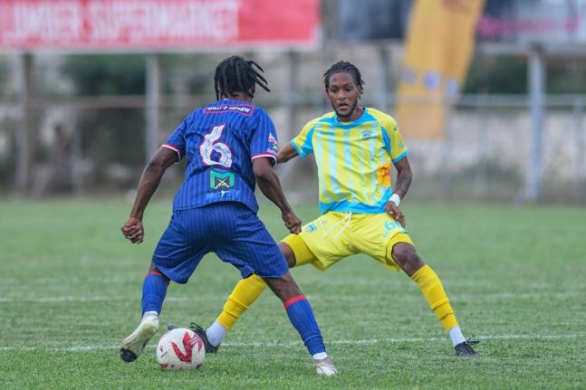 Spanish Town Police’s Shavan James (left) tries to take on Waterhouse’s Shamarie Dallas during a Jamaica Premier League match at the Anthony Spaulding Sports Complex yesterday. Spanish Town won the game 1-0.