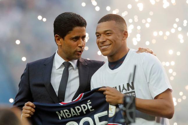 PSG President Nasser Al-Khelaifi, left, speaks to PSG's Kylian Mbappe as it is announced he has signed a three year extension to his contract, at the Parc des Princes stadium in Paris, France on May 21, 2022. 