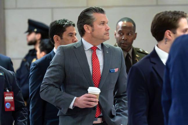 United States Defense Secretary Pete Hegseth walks to the auditorium to brief members of Congress on military strikes near Venezuela at the Capitol on December 16, 2025, in Washington.