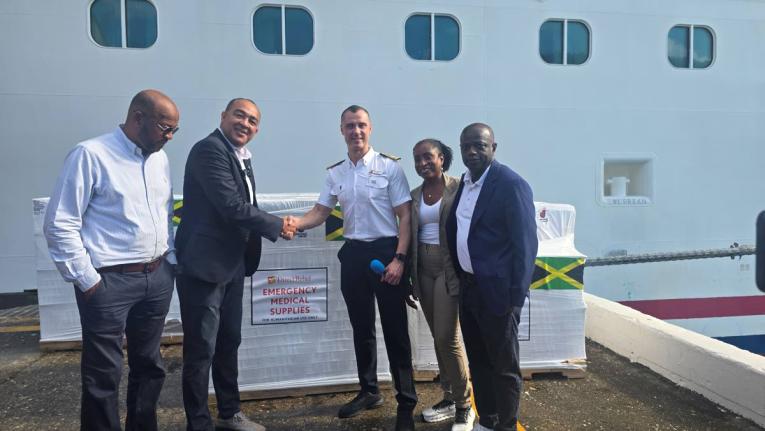 Minister of Health and Wellness Dr Christopher Tufton (2nd left) greets Carnival Horizon Captain Nick De Ranieri (centre) during the handing over ceremony of 24 pallets of medical supplies for hurricane relief purposes at the Reynolds Pier in Ocho Rios, St