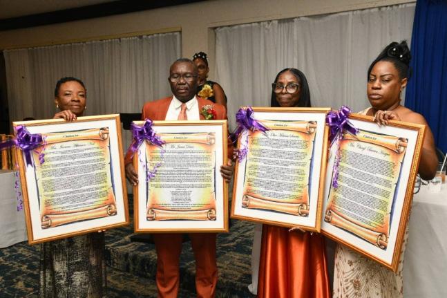 The four retired educators at the St Catherine-based Jonathan Grant High School, display their citations. They are (from left) Textbook Administrator, Ivorene Neil; Vice Principal, James Davis; Internal Examination Coordinator, Olive Simms; and Textbook Ad