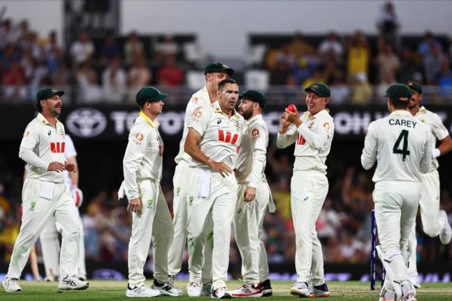 Australia’s Scott Boland (centre) celebrates with teammates after capturing the wicket of England’s Ben Duckett during the second Ashes cricket Test match between Australia and England in Brisbane, Saturday, December 6, 2025.