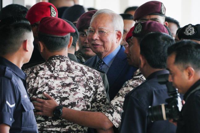 Malaysian former Prime Minister Najib Razak, centre, is escorted by prison officers on his arrival at the Kuala Lumpur High Court complex in Kuala Lumpur, Malaysia on October 30, 2024. 