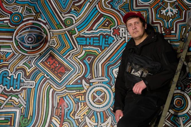 Ukrainian street artist Maxim Kilderov stands by his painting containing symbols and messages of resistance in his private museum that displays a collection of battlefield artefacts documenting Russia’s invasion of Ukraine in Kyiv.