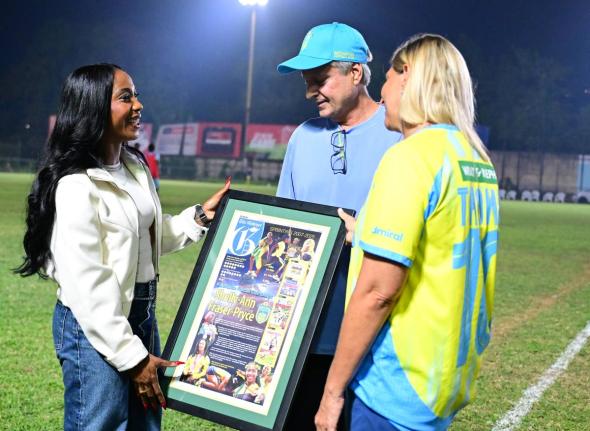 From left: Sprint legend Shelly-Ann Fraser-Pryce in dialogue with Bruce Bicknell, chairman, Waterhouse FC, and Nicola Bicknell, director, Waterhouse FC, moments after a presentation ceremony at the Waterhouse football field in Drewsland on Sunday.
