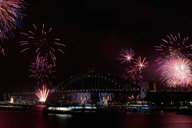 Fireworks burst over the Sydney Harbour Bridge as New Year's celebrations begin in Sydney, Wednesday, December 31, 2025. (AP Photo/Rick Rycroft)