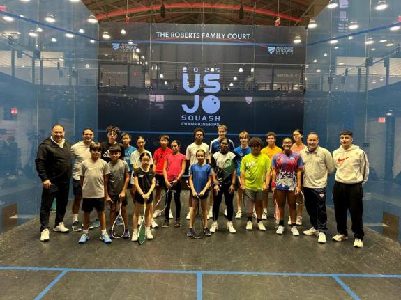 Maximillian Woolf (front row, in green)  and Kaylee Pierre, in red, blue and white, with other junior competitors at a pre-tournament clinic at the US Junior Open. 