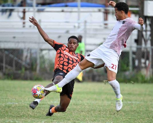 Tivoli Gardens’ Janoi Williams (left) makes a sliding tackle on Marcos Pegoretti Roas Filho of Chapelton Maroons during their Jamaica Premier League match at the Edward Seaga Sports Complex on Monday, December 29, 2025.