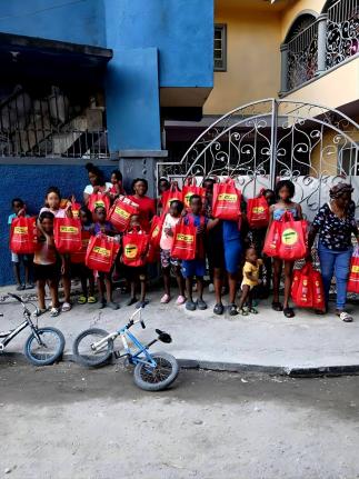 Children from the Barbican community in Kingston, and their families, receive care packages with food items and school supplies during Fontana’s annual New Year’s Day treat on January 1. The initiative, which has been staged for more than a decade with