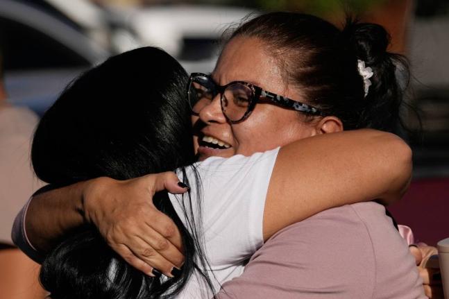 Relatives of detainee Yosnars Baduel embrace outside the Rodeo I prison in Guatire, Venezuela, Thursday, January 8, 2026, after National Assembly President Jorge Rodriguez said the government would release Venezuelan and foreign prisoners. (AP Photo/Matias