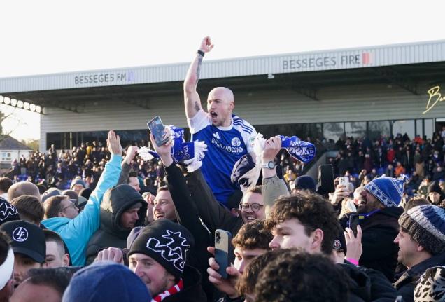 
Macclesfield Town’s Josh Kay celebrates with fans following the FA Cup third round football match against Crystal Palace at the Leasing.com Stadium, Macclesfield, England, yesterday.
