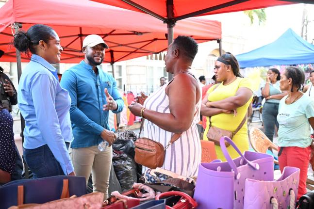 Mayor of Montego Bay and Chairman of the St James Municipal Corporation, Councillor Richard Vernon, along with Chief Executive Officer, Naudia Crosskill (left), engages vendor, Minorah Robinson (centre), and others during a visit with vendors across downto