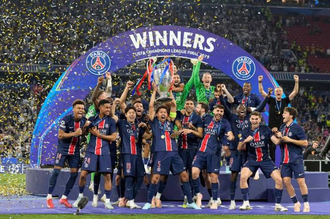 PSG’s Marquinhos holds up the trophy as he celebrates with his teammates after winning the Champions League final fooball match against Inter Milan at the Allianz Arena in Munich, Germany, on Saturday, May 31, 2025.